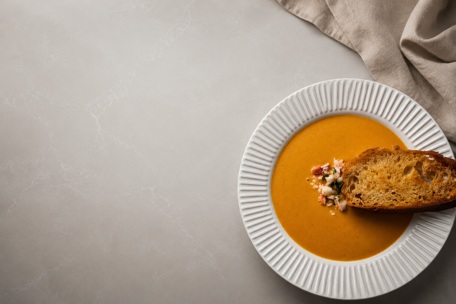 Elegant bowl of soup plated on marble